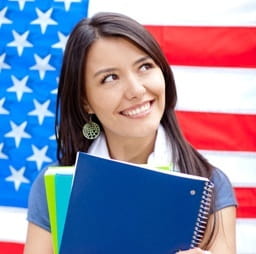 Female student in front of American flag